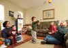 Stephanie Mertz, left, holds their 1-year-old son, Samuel, as her husband, James, right, plays with their 3-year-old son, Isaac, while their 8-year-old son, Eli, and daughter, Grace, 10, watch on Saturday in their Prairie Grove home. The Mertzes adopted Isaac and Sam, both of whom have Down syndrome.