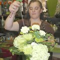 Trish Upshaw puts the finishing touches on a St. Patrick’s Day bouquet Tuesday preparing for deliver...