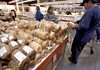 Customers look at bagels at a Costco wholesale club store in Mountain View, Calif., earlier this month. The Labor Department said Wednesday that wholesale inflation dropped 0.6 percent in February.