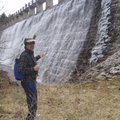 Doug Powell admires a waterfall that spills from the Lake Leatherwood dam.