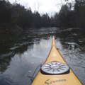 A kayak breaks ice in a cove at Lake Leatherwood.