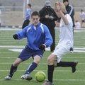 Rogers High’s Spencer Dunlop, left, dribbles around teammate Julian Tietze during practice Wednesday...