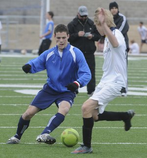 Rogers High’s Spencer Dunlop, left, dribbles around teammate Julian Tietze during practice Wednesday.