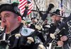  Joseph O'Keefe, left, puffs his cheeks as he blows a bagpipe as the Department of Sanitation of New York's Emerald Society Pipes and Drums marches during the St. Patrick's Day parade in New York, Wednesday, March 17, 2010. 