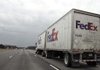  In this photo made Jan. 25, 2010, a Fed Ex truck drives along the highway near Mansfield, Ohio. FedEx, the world's second-largest package delivery company, on Thursday, March 18 said its fiscal third-quarter profit more than doubled from a year earlier. 