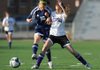 CONFERENCE COLLISION - Rogers Heritage’s Alex Smith, left, and Fayetteville sophomore Ashley Davidson collide while attempting to control the ball during the first half Thursday at Harmon Field in Fayetteville.