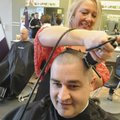HAIR TODAY, GONE TOMORROW - Rogers firefighter Marc Dyer gets a buzz cut from Sheila Mounce on Thurs...