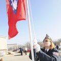 SHOW OF FLAGS - Barbara Aguirre of Rogers American Legion Post raises state and American flags Thurs...