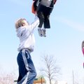 SWING INTO SPRING - Caleb Brummett, 3, gets a push on a swing Friday from cousin Ben Masten, 9, at D...
