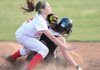  Farmington shortstop Michaela Larabee, left, collides with Springdale’s Laura Worthen after tagging out Worthen during the second inning of the Lady Cardinals’ 2-1 win Friday in Farmington.