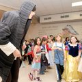 A ‘GRIMM’ EVENT - Costumed second-graders look to The Hunchback, played by teacher Ilena Davis, for ...