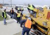 BACK ON THE STREETS - A crew with the Springdale Street Department pave a section of the road Tuesday on the East bound lane of Randall Wobbe Lane in Springdale. Certain roads are getting repaired after they received damaged from the past ice storms.