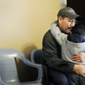 Miguel Hernandez hugs son Rudy on Wednesday at the apartment the family is renting in Springdale.