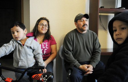 
                               
                                  Photo by Sarah Bentham&mdash;
                               
                           
                           The Hernandez family from left, Aaron, Maricela, Miguel, and Rudy sit in the apartment Wednesday they are renting in Springdale. The apartment is temporary housing while the home undergoes extensive repair following a lightning strike in June.