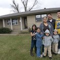 Miguel and Maricela Hernandez, center, stand outside their house in Springdale with their children, ...