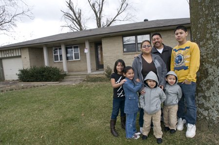 
                               
                                  Photo by Spencer Tirey&mdash;
                               
                           
                           Miguel and Maricela Hernandez, center, stand outside their house in Springdale with their children, from left to right, daughters Brisa, Roselyn, twins Aaron and Rudy and oldest son Angel. The family fought for more than a year to save the home from foreclosure.