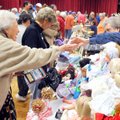 BARGAIN HUNTERS - Gerry Farnsworth, left, reaches to pay Jeanne Reif for a clown doll Saturday at th...