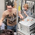 Dallas Harris, left, and employee Mark Zebley unpack a shipment of T-shirts Friday at Overlooked in ...