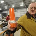  Joe Fancher, general manager of Brunner & Lay Inc. in Springdale holds a coupler made at the Spring...