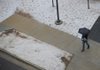 A pedestrian tries to stay dry while walking along Duncan Avenue in Fayetteville as an ice and snow mix began to fall on the area Saturday afternoon.