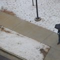 A pedestrian tries to stay dry while walking along Duncan Avenue in Fayetteville as an ice and snow ...