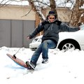 Pete Child takes a spill trying to sled on very wet snow Sunday in front of Bethel Baptist Church in...