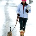 Jan Smith walks her 5-month-old dog Gypsy along Southwest “E” Street during Sunday’s heavy snowfall ...