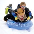 Ed Osoris of Springdale and his 7-year-old daughter, Sydney, ride an inflatable pool toy down a hill...