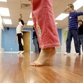  
Liviyah (cq) Blackmon (center), 8, of Bentonville and other students stand up on their toes while...
