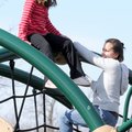 Destiny Arevalo, 7, awaits rescue by her mother, Melissa Arevalo, Monday from her perch on top of a ...