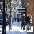 Adam Booker, center, and girlfriend Amy Wolfe walk back to the Fayetteville square through snow alon...