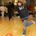Lauren Hogue, 7, scores nine of 10 pins Monday at Rogers Bowling Center. Lauren and others from the ...
