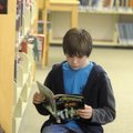 Harrison Strouse of Springdale reads a graphic novel Monday at the Springdale Public Library. The li...