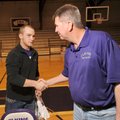 Elkins senior Andrew Brink, left, shakes hands with Elkins football coach Aaron Clark after signing ...