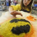 Caroline Stewart, 7, of Fayetteville puts the finishing touches on her papier mache beetle Tuesday d...