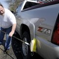 Robert Rakes washes his truck Tuesday outside his Rogers home. Rakes wanted to save a little bit of ...