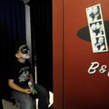 Jacob Brown, 4, of Gravette smiles Tuesday as he gets his picture taken inside a photo booth at The ...