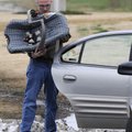 Michael Dowd, a Benton County Sheriff’s office employee, installs a child safety seat in a vehicle W...