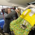 Sarah Gibson, a Fayetteville police officer, installs a child safety seat in a vehicle Wednesday dur...
