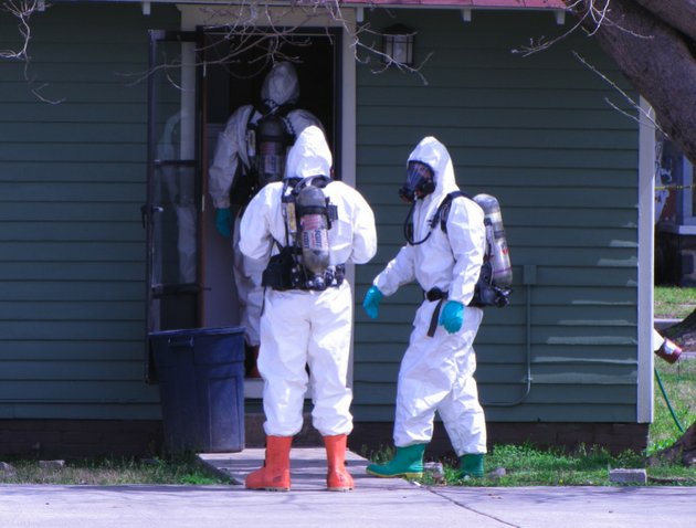 members-of-the-north-little-rock-fire-department-hazardous-materials-team-enter-a-home-where-a-body-and-a-bucket-of-unknown-chemicals-were-found-thursday