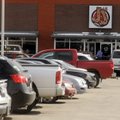 A customer pulls into a parking spot Tuesday at a retail center at 4500 W. Walnut St. in Rogers. Pat...