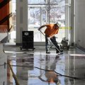 Jose Velasquez cleans the floors Monday of the lobby in the new addition of Springdale High School.