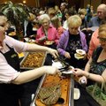 RUSTLIN’ UP SOME TREATS - Treasure Nelson, left, serves Richelle Fry of Springdale samples of sirloi...