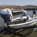Robert Hope of Springdale climbs aboard while launching his boat on Friday at Prairie Creek park. Se...