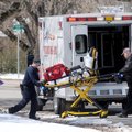 A Rogers Fire Department ambulance crew loads medical equipment Monday into an ambulance after respo...