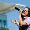  Amber Tejada of Farmington sings the national anthem Saturday at Arvest Ballpark in Springdale. Tej...