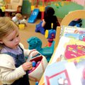 Lynden Osborn, 3, of Garfield hunts for eggs Sunday in the nursery of the First Baptist Church in Pe...