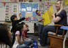 Margo Acuff reads a book that her kindergarten students created Friday at Turnbow Elementary School in Springdale. Registration begins April 1 for kindergarten in the Springdale school distrcit and officials are encouraging parents to sign their children up early.