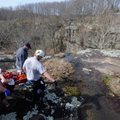 Rescue personnel carry Randy Curtis, 46, of Rogers, after pulling him up a cliff near Winslow on Tue...