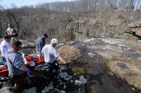Rescue personnel carry Randy Curtis, ...